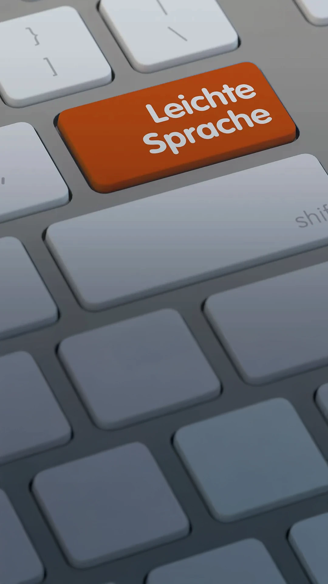 Mobil-First-B2B-Leichte-Sprache-Kassel-Hessen-Deutschland-Agentur-Werbung-Inklusion Kopie Eine graue Computer-Tastatur mit orangener Enter-Taste. Darauf steht: "Leichte Sprache"